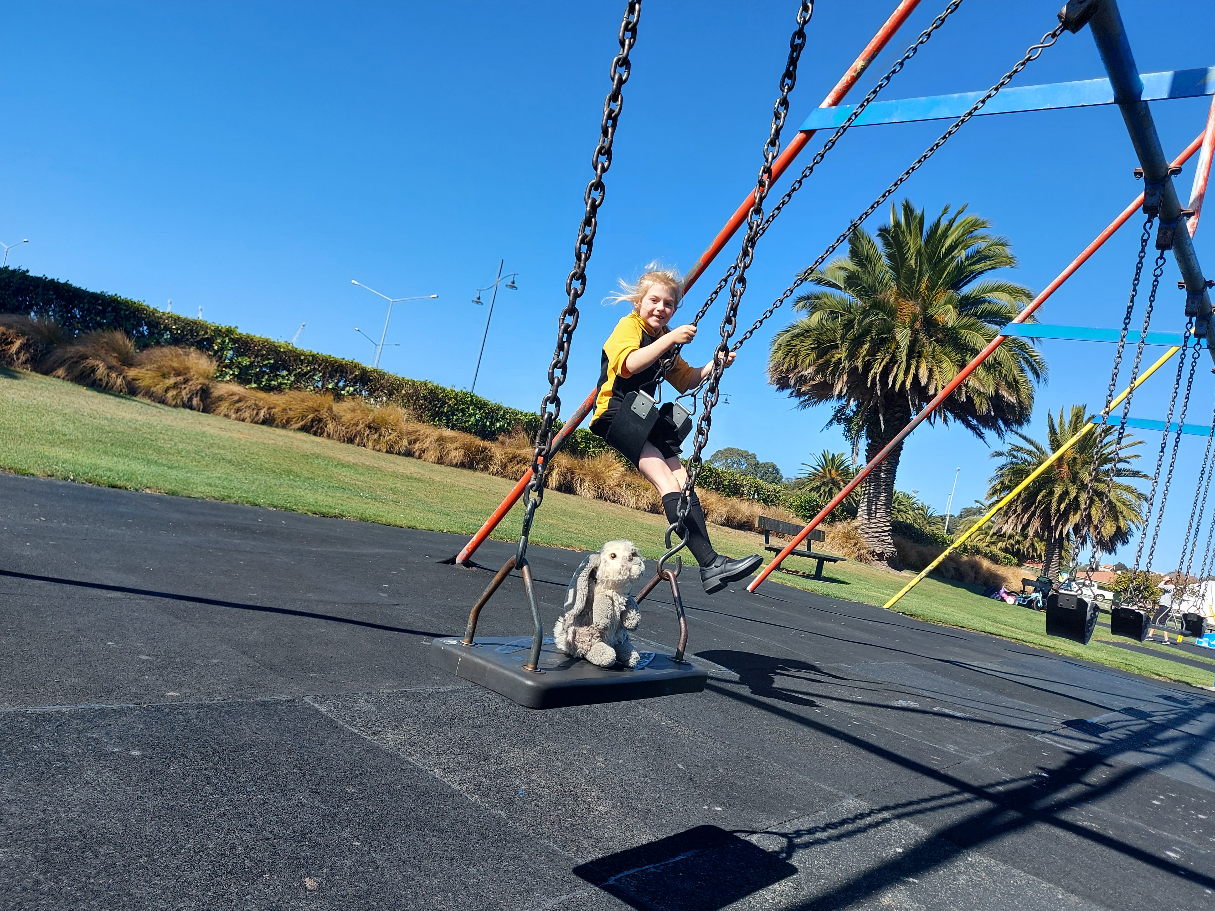 Medinella Fauth playing on the Swings at the Caroline Bay Playground 2021